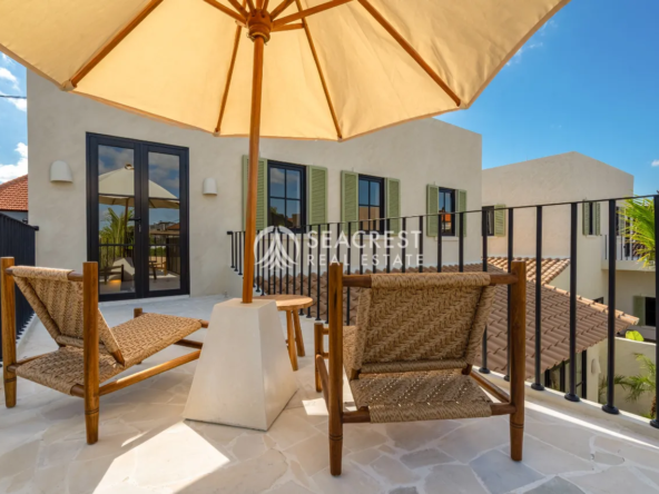 Sunny terrace with seating and umbrella
